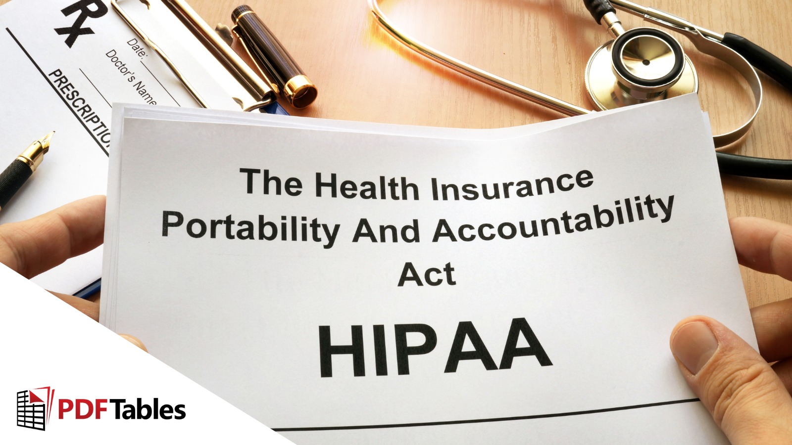 A desk with paper saying 'The Health Insurance Portability and Accountability Act HIPAA'.